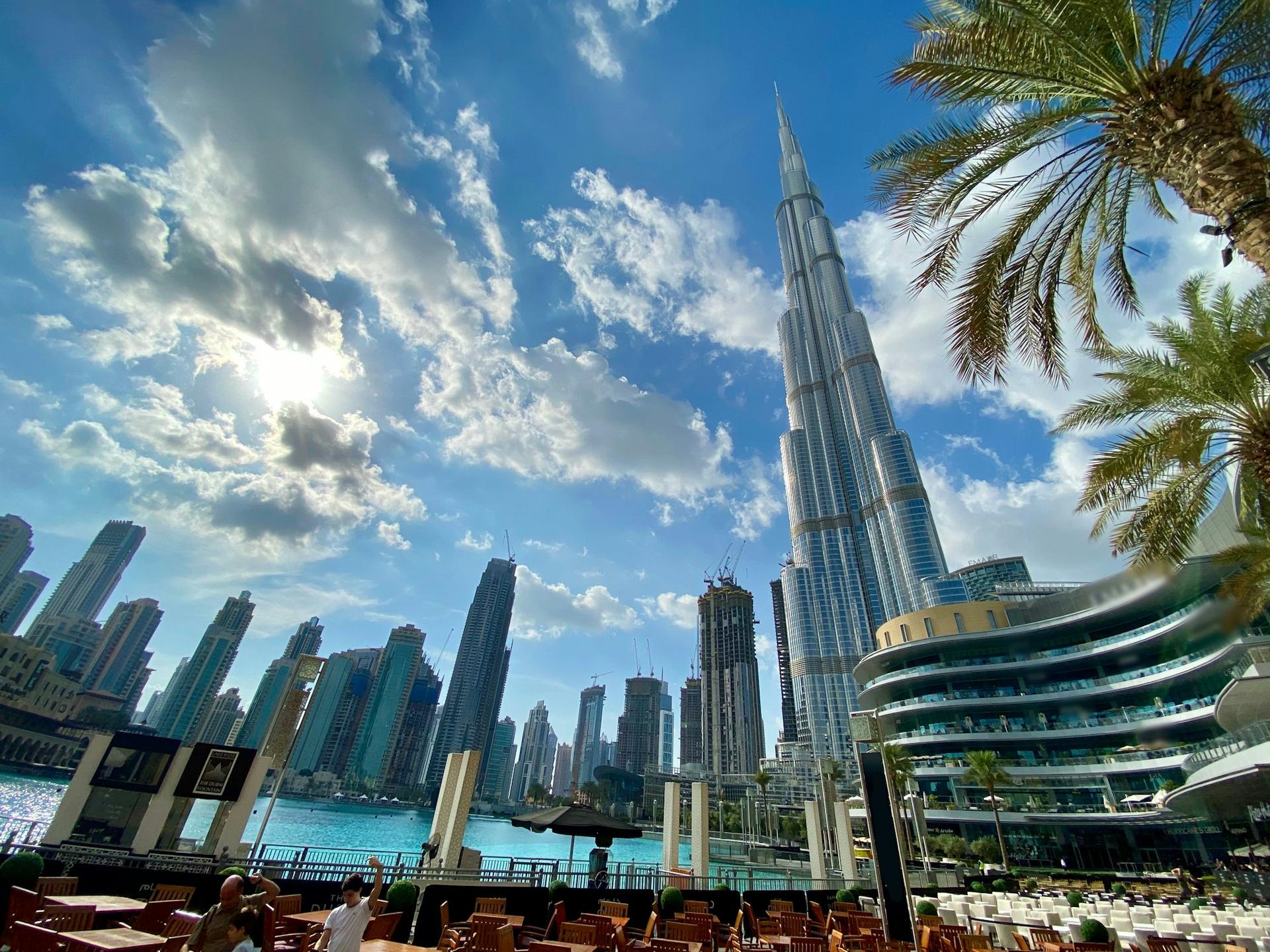 Burj Khalifa seen from below between palm trees